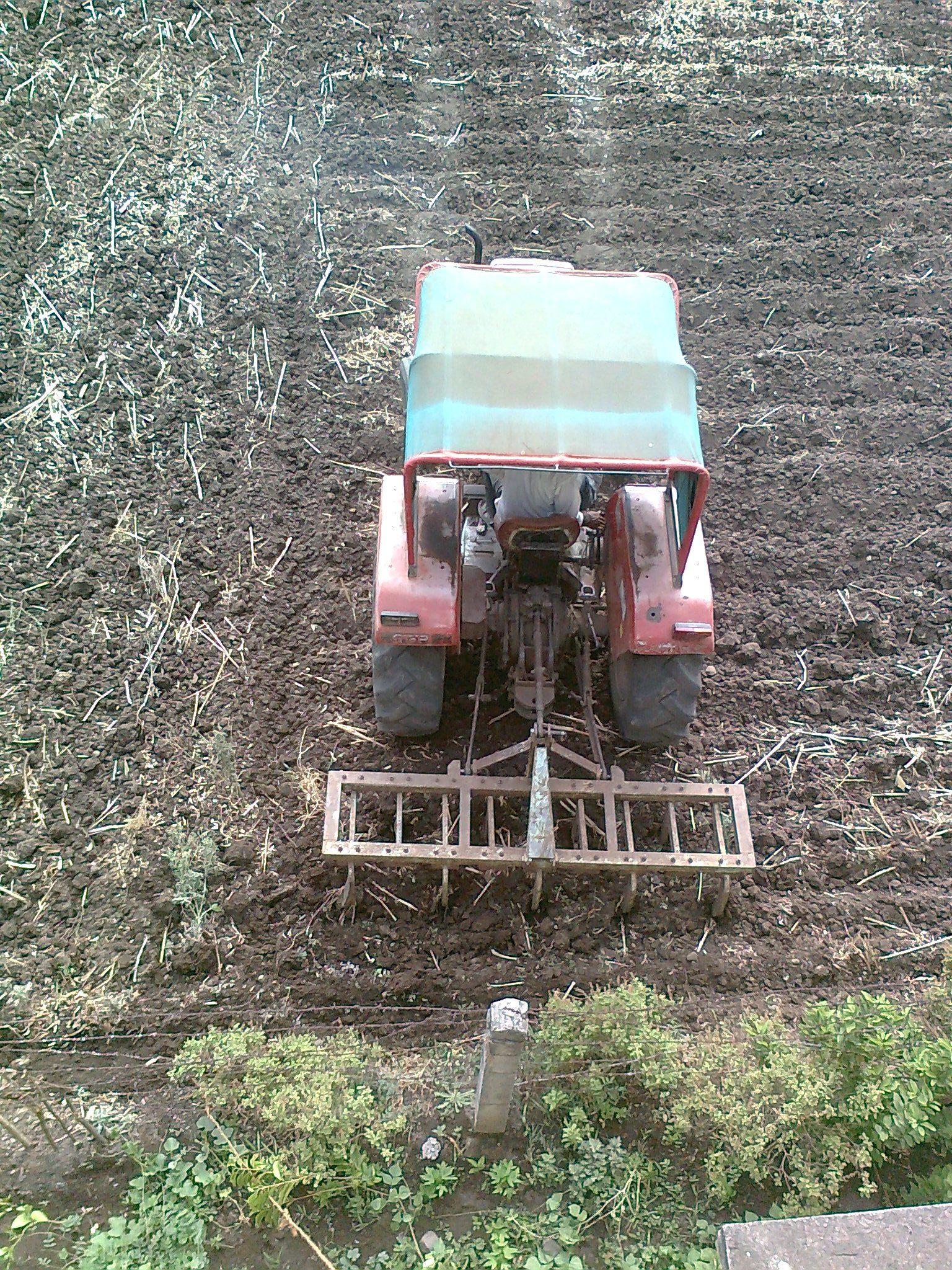 A tractor working a prepared field